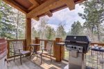 Iron Horse Cabin deck with gas grill and forest views. 